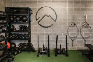 Two training sleds and kettlebell storage rack at EVOLVE Flagstaff gym