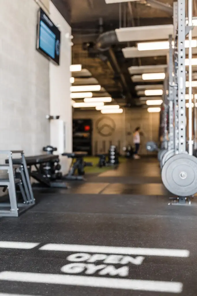 Plyometric boxes and squat rack with indoor turf in the background at EVOLVE Flagstaff