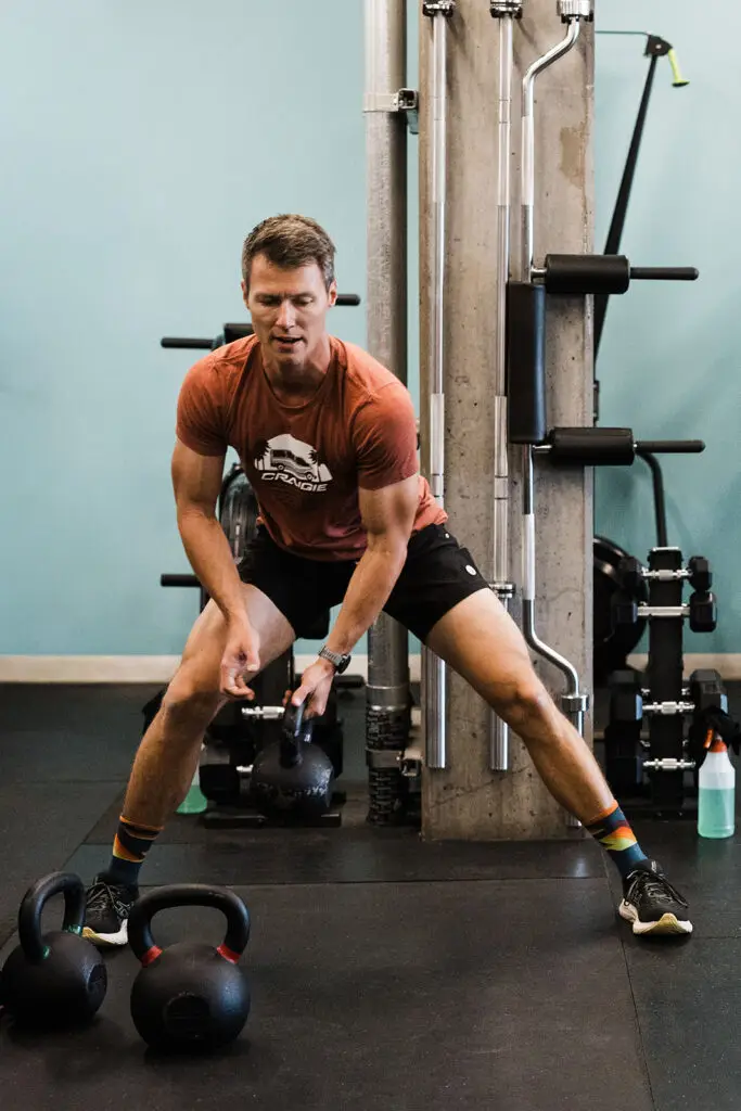 A man performing a lateral lunge with a kettlebell at the Evolve Flagstaff gym